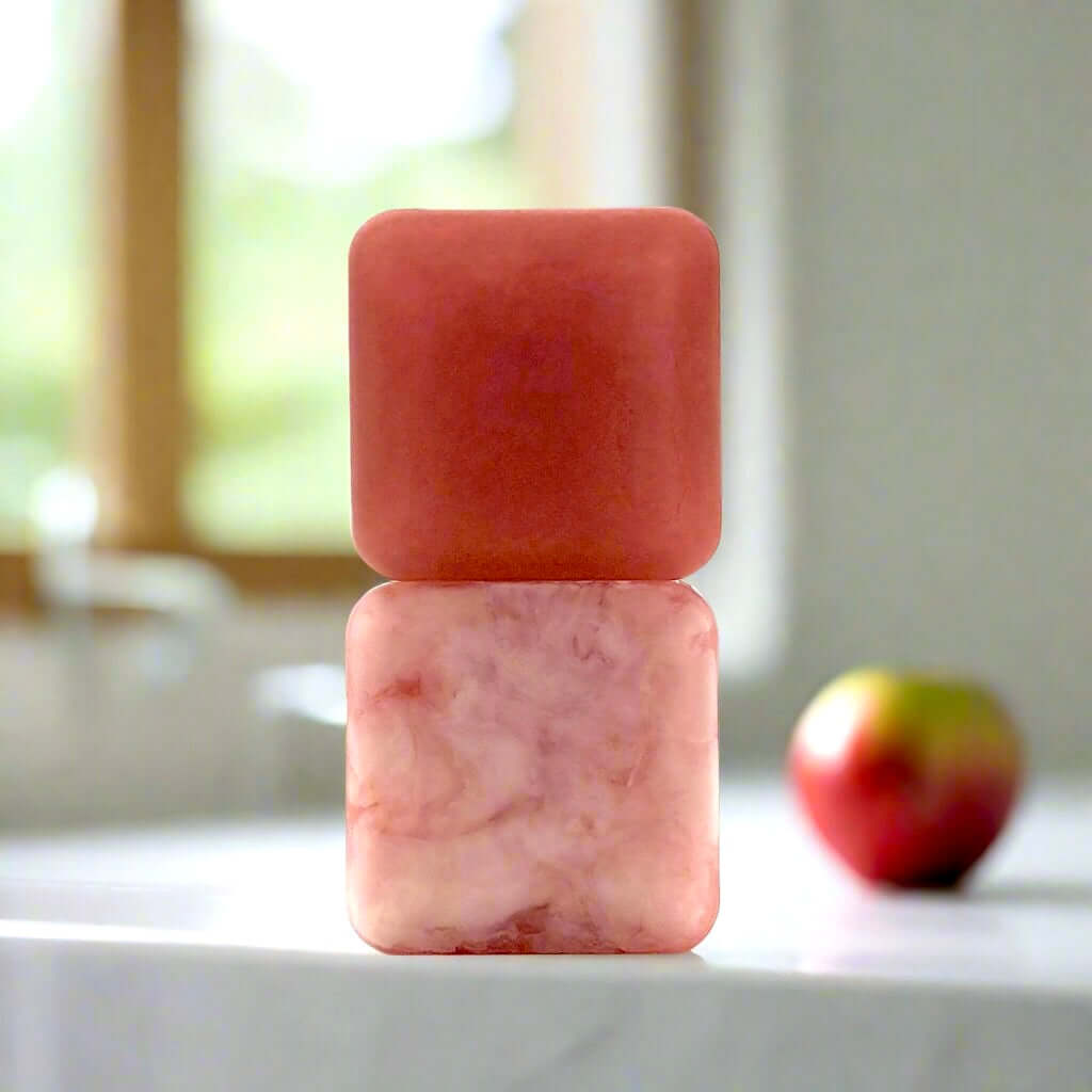 Two stacked bars of Macintosh Music soap on a white kitchen counter in front of a bright window.